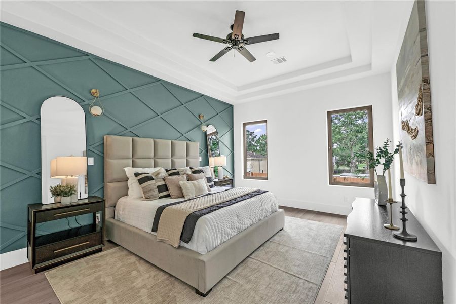 Step into the owner’s oasis, where an elegant feature wall, stylish sconces, and backyard-facing windows create a serene retreat.