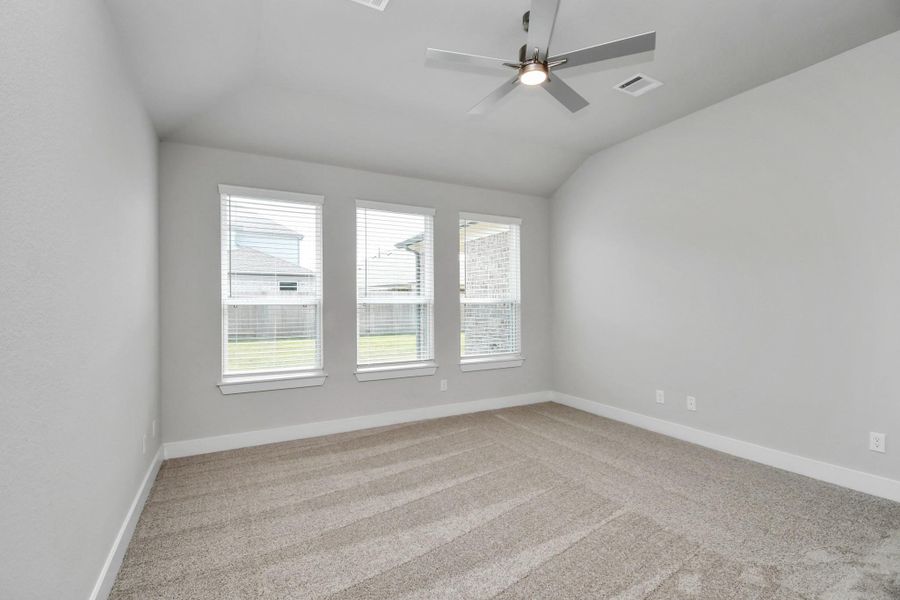 Retreat to the luxurious primary suite, your perfect escape for unwinding after a long day. Located on the first floor, this spacious room features plush carpeting, calming paint tones, high ceilings, and large windows with privacy blinds. Retreat to the luxurious primary suite, your perfect escape for unwinding after a long day. Located on the first floor, this spacious room features plush carpeting, calming paint tones, high ceilings, and large windows with privacy blinds.