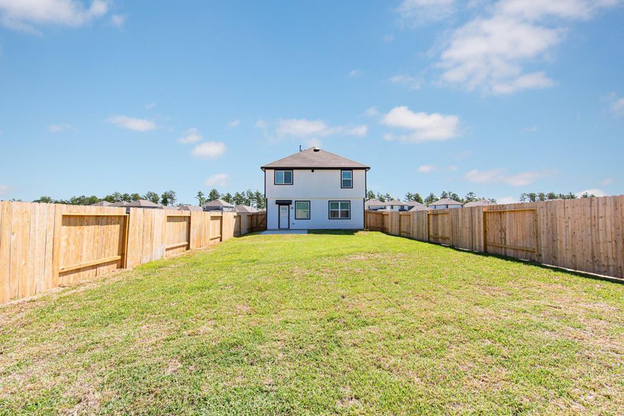 Front exterior of a new home in Townsend Reserve, Splendora, TX, highlighting curb appeal (Image 2).