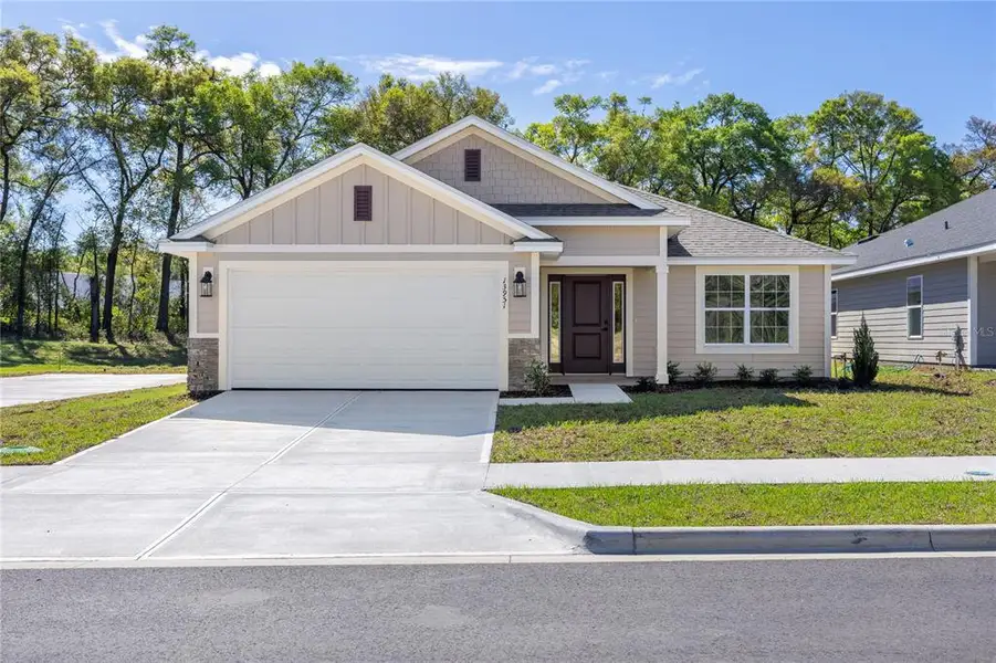 Front exterior of a new home in Briarwood, Alachua, FL, highlighting curb appeal (Image 25).