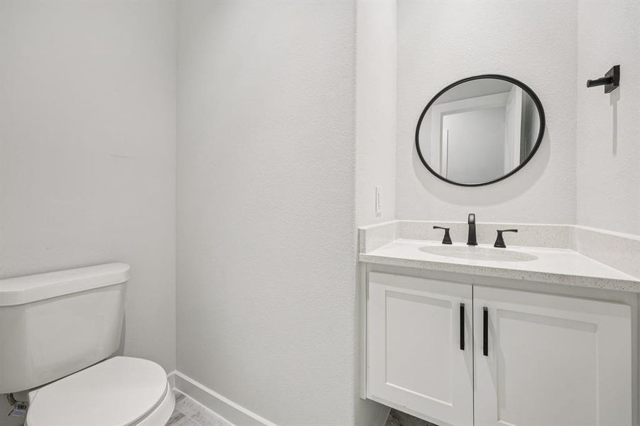 Half bath with toilet and vanity Half bath with toilet and vanity