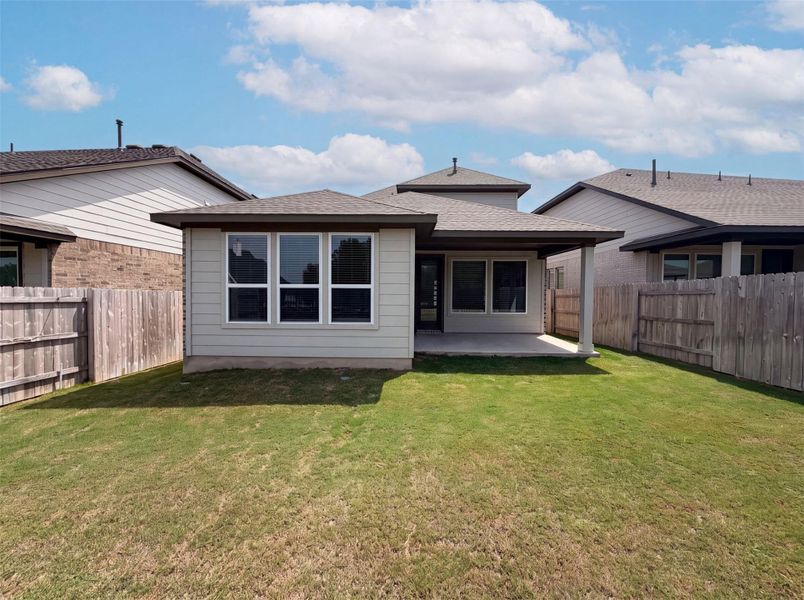 A fenced, well-maintained yard provides a private setting for outdoor living, featuring a covered patio for relaxed entertaining. A fenced, well-maintained yard provides a private setting for outdoor living, featuring a covered patio for relaxed entertaining.