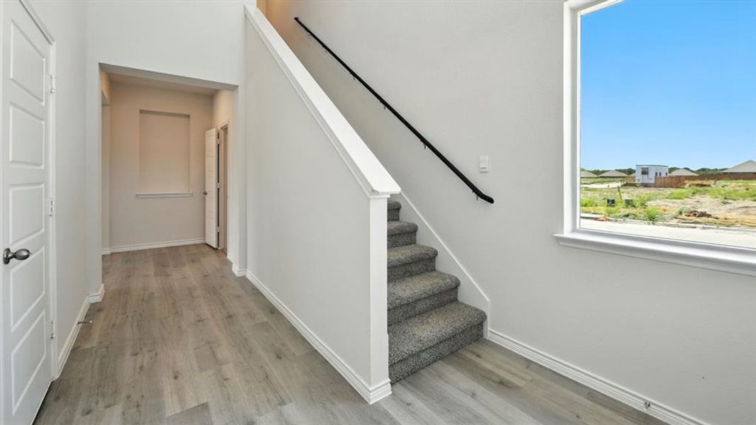 Staircase with baseboards and wood finished floors