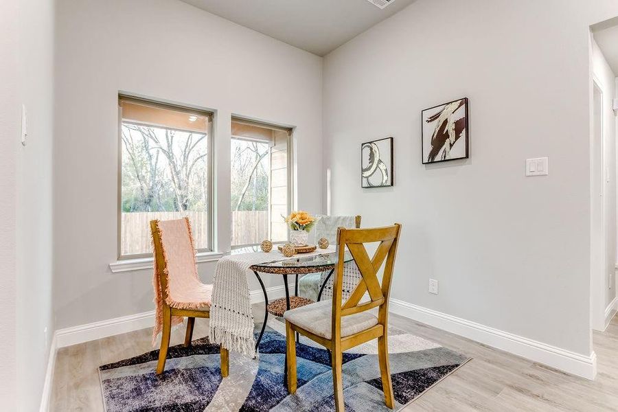 Dining area with light wood-type flooring