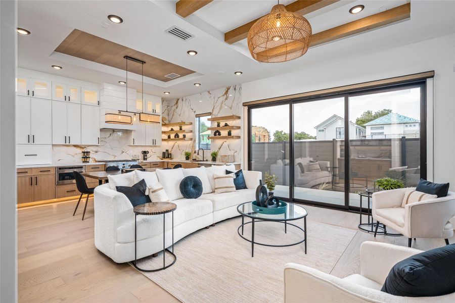 A spacious open-concept layout flows effortlessly from the grand living area to the elegant dining space and chef’s kitchen