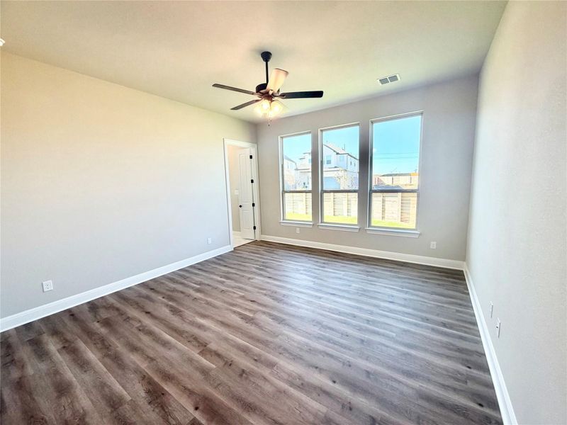 Unfurnished room with wood finished floors and ceiling fan Unfurnished room with wood finished floors and ceiling fan