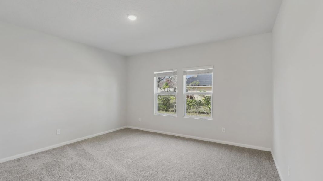Experience serene elegance with plush gray carpeting and abundant natural light at Merritt, Palm Coast.