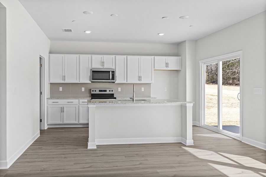 A kitchen with white cabinets. A kitchen with white cabinets.