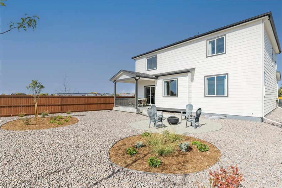 A house with a patio and a table and chairs in the front. A house with a patio and a table and chairs in the front.