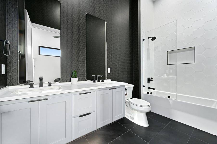 Full bath featuring wallpapered walls, tile patterned floors, toilet, and a sink