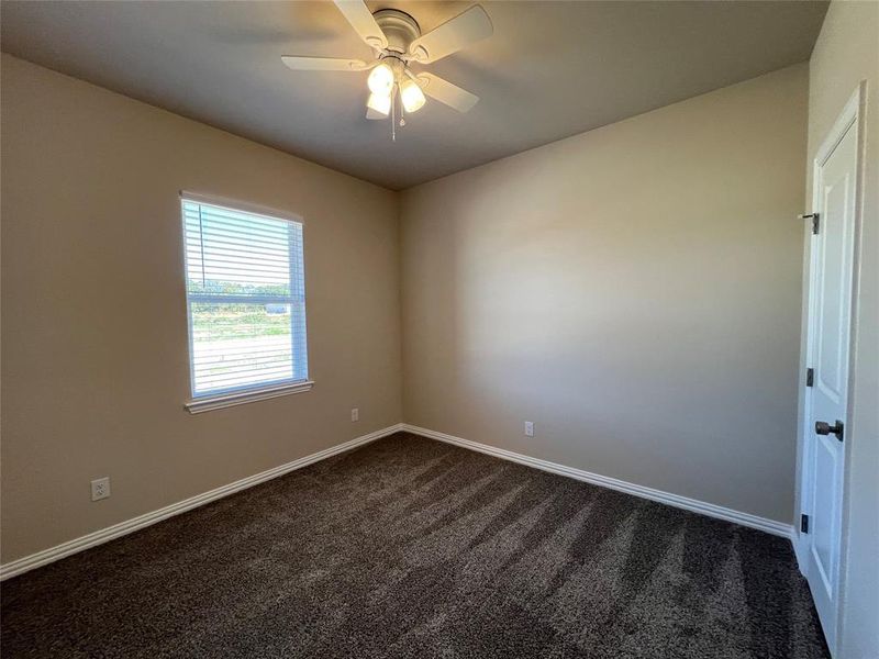 Bedroom 3 with ceiling fan and dark carpet