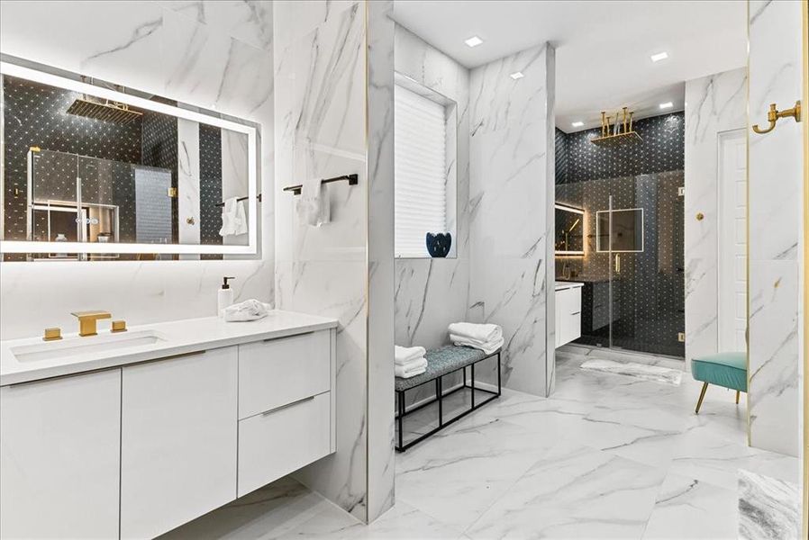 Primary Bathroom with his-hers vanity, a walk-in shower, floor to ceiling designer tile and touch light control mirror