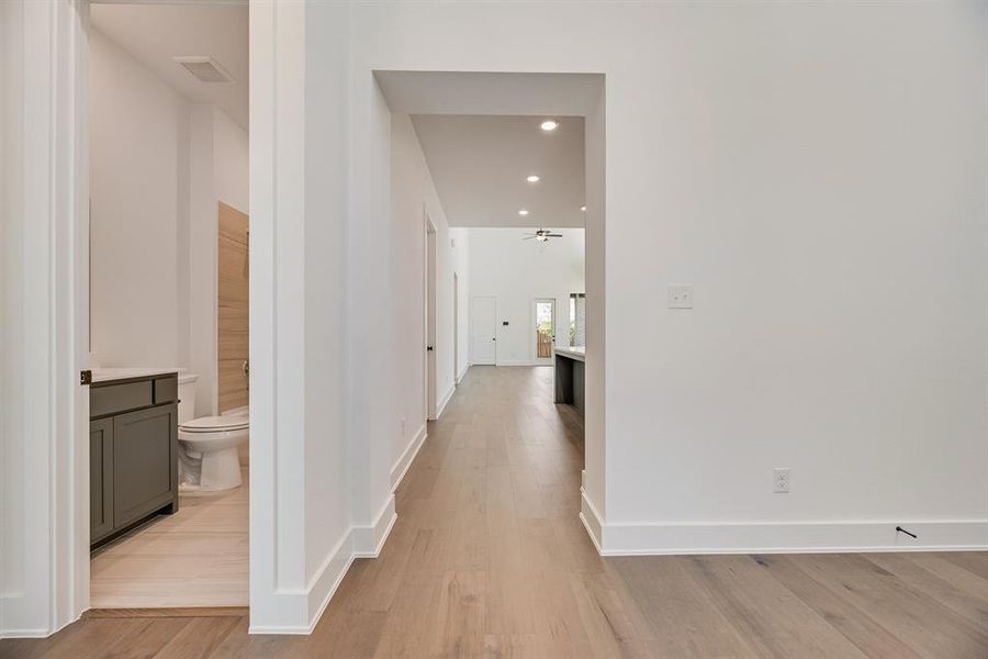 Hallway featuring recessed lighting and light wood-style floors Hallway featuring recessed lighting and light wood-style floors