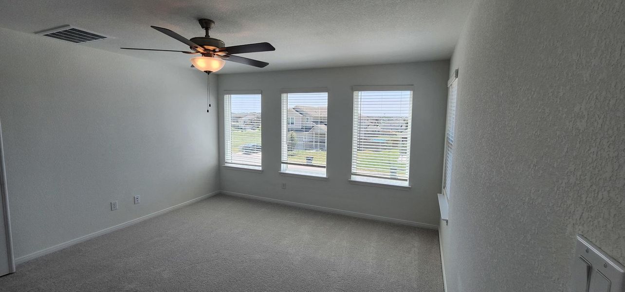 A quiet, naturally illuminated bedroom offers a tranquil retreat with soft carpeting. A quiet, naturally illuminated bedroom offers a tranquil retreat with soft carpeting.