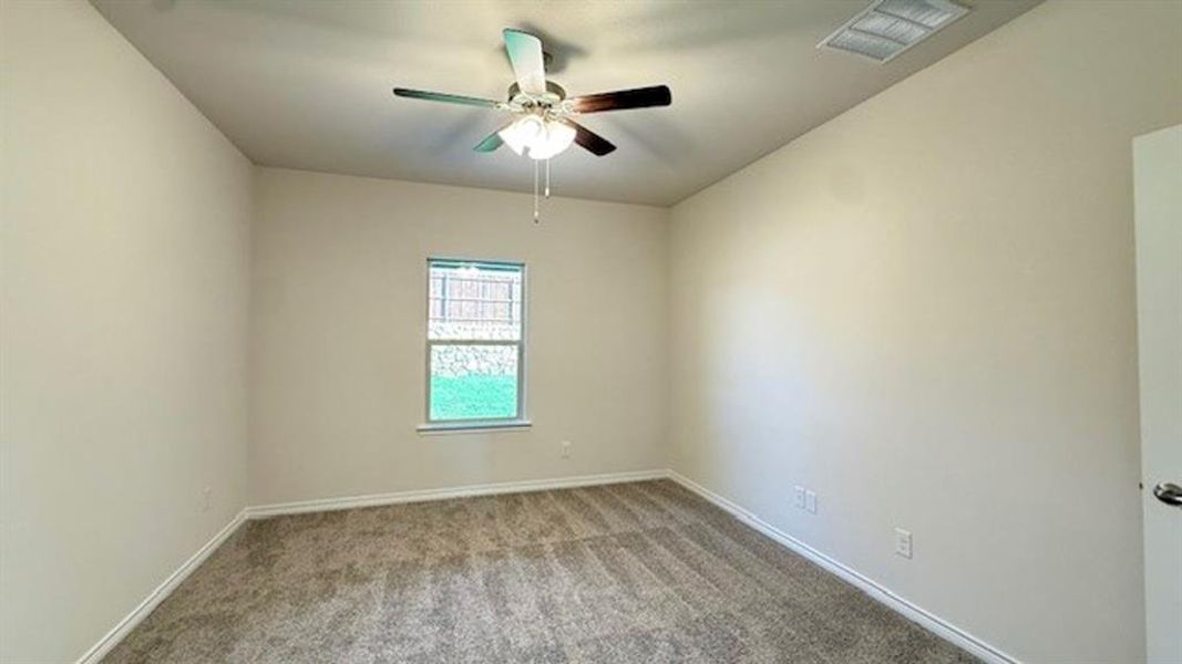 Unfurnished room featuring carpet and ceiling fan Unfurnished room featuring carpet and ceiling fan