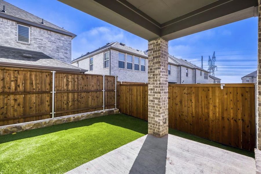 Fenced backyard with a patio