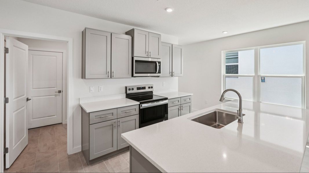 Kitchen and Island of the Jupiter in Hamilton Bluff located in Haines City, FL.