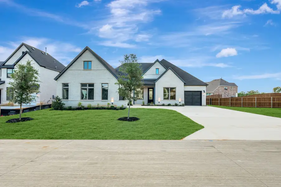 Front exterior of a new home in Northshore at Lakewood Village - Classic Series, Lakewood Village, TX, highlighting curb appeal (Image 1). Front exterior of a new home in Northshore at Lakewood Village - Classic Series, Lakewood Village, TX, highlighting curb appeal (Image 1).