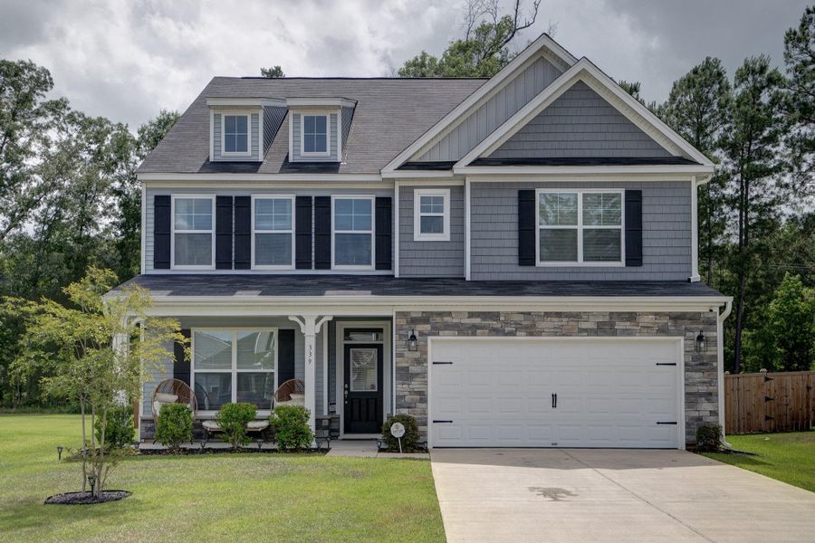 Front exterior of a new home in Oakley Pointe, Moncks Corner, SC, highlighting curb appeal (Image 2). Front exterior of a new home in Oakley Pointe, Moncks Corner, SC, highlighting curb appeal (Image 2).