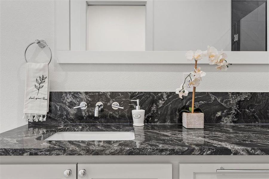 Bathroom view of double vanity and a textured wall Bathroom view of double vanity and a textured wall