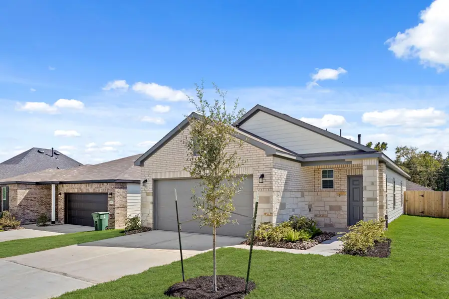 A house with a tree in the front yard. A house with a tree in the front yard.