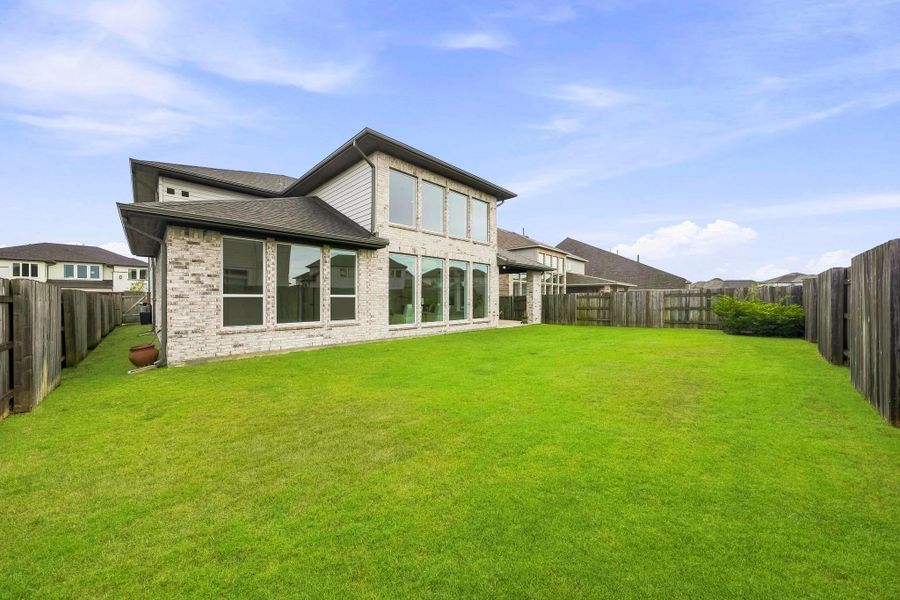 This fully fenced backyard provides plenty of room for pets to roam, play and enjoy the outdoors, while an integrated French drain helps maintain the grounds.