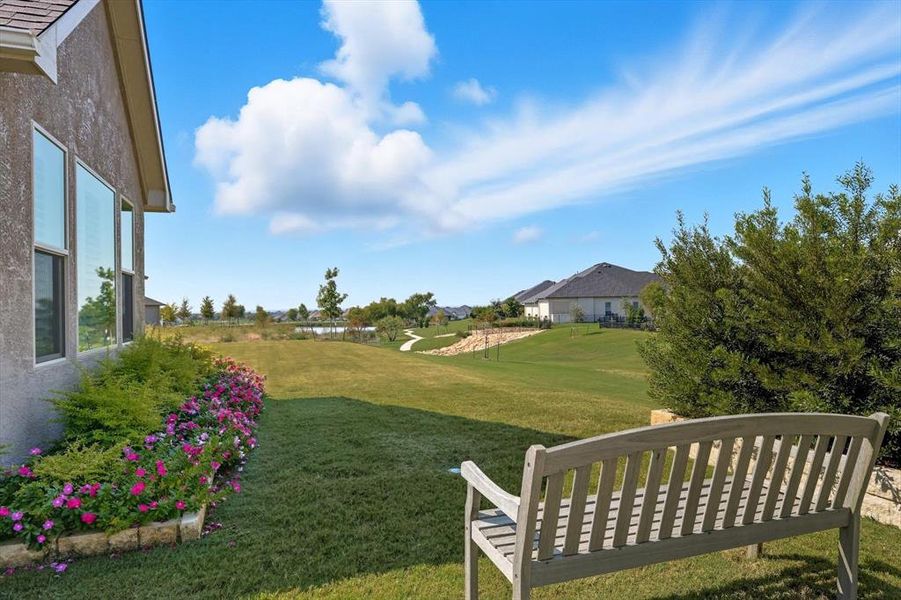 View of green lawn with a water view
