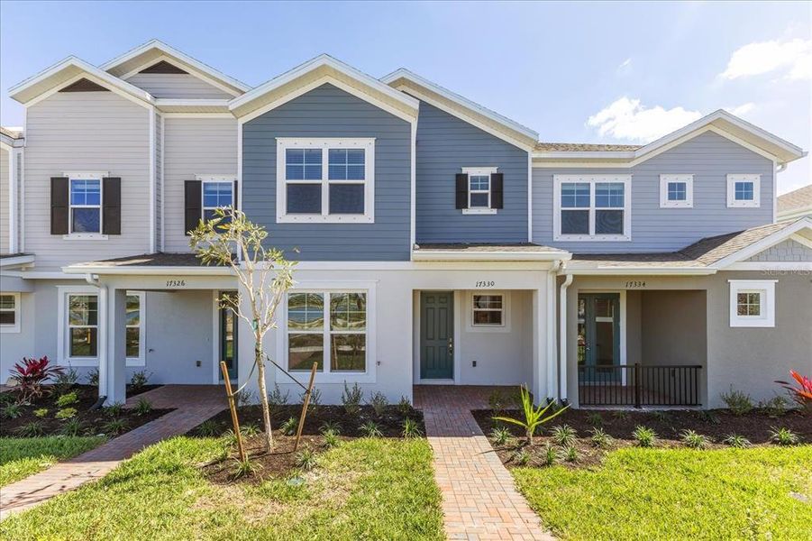 Front exterior of a new home in The Residences at Emerson Park, Apopka, FL, highlighting curb appeal (Image 1).