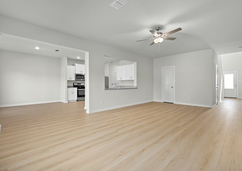 Open floor plan with beautiful light vinyl plank flooring creates a bright living environment. Open floor plan with beautiful light vinyl plank flooring creates a bright living environment.