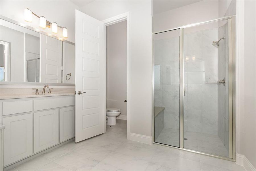 Bathroom featuring vanity and a stall shower