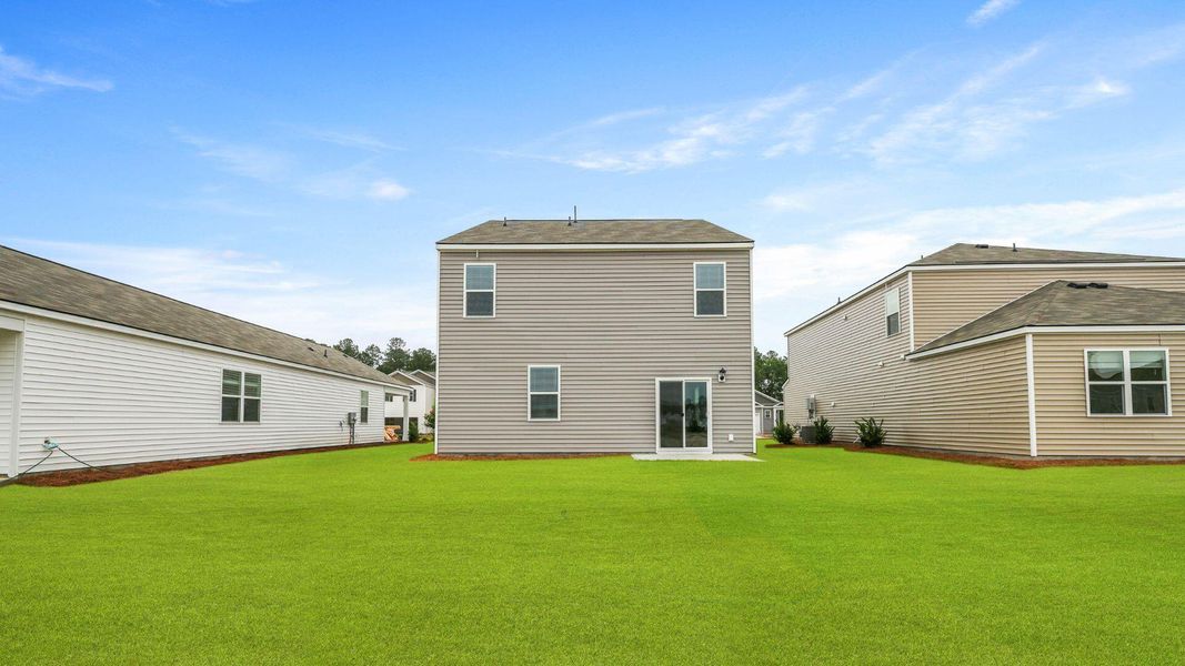 Exterior details and patio area of a home in Pine Hills at Cane Bay, Moncks Corner (Image 19).