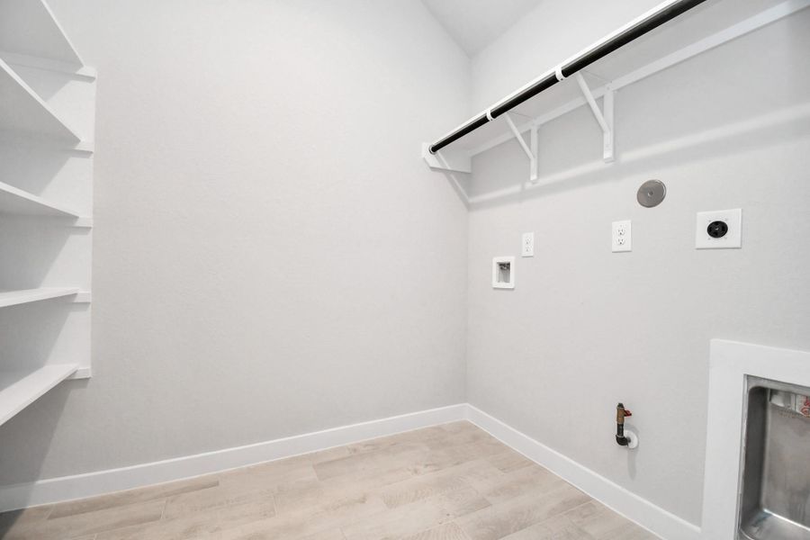 A perfect blend of functionality and comfort. Capture the essence of easy living with a first-floor laundry room, thoughtfully equipped with shelving for effortless organization. Both electric and gas connections available. A perfect blend of functionality and comfort. Capture the essence of easy living with a first-floor laundry room, thoughtfully equipped with shelving for effortless organization. Both electric and gas connections available.