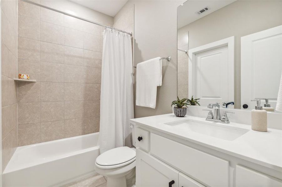 Full bathroom with vanity, toilet, and shower / bathtub combination with curtain