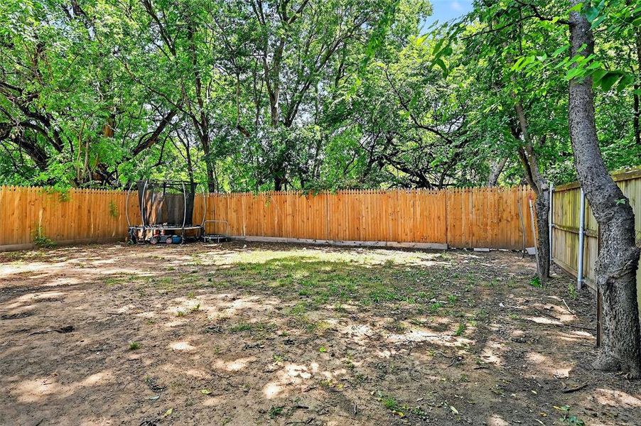 Fenced backyard with a trampoline Fenced backyard with a trampoline
