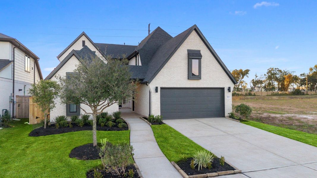 Front exterior of a new home in Sienna 45', 50', Missouri City, TX, highlighting curb appeal (Image 21). Front exterior of a new home in Sienna 45', 50', Missouri City, TX, highlighting curb appeal (Image 21).