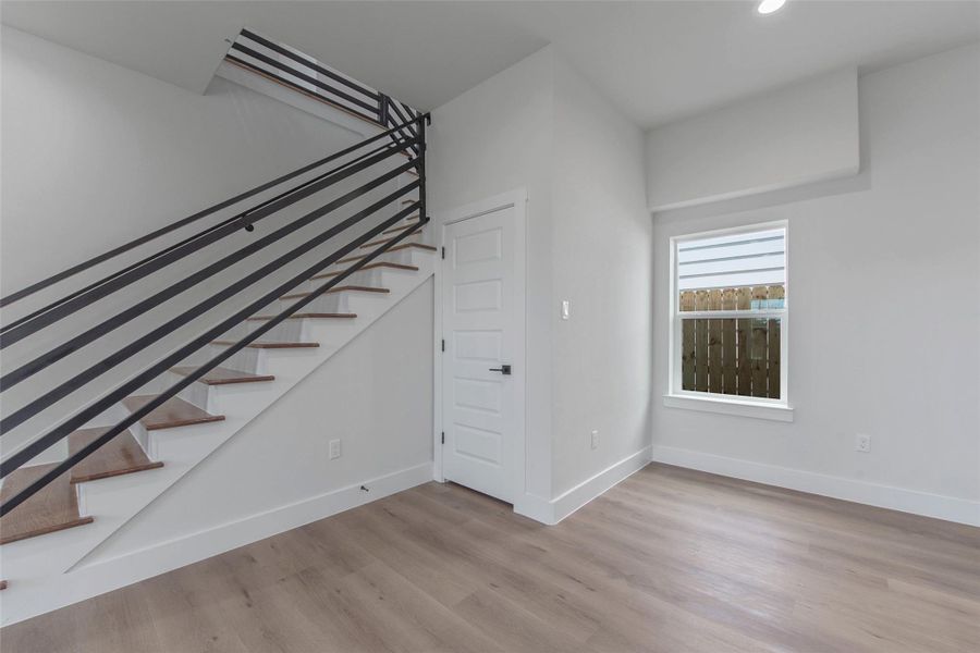 Wrought iron-accented stairs lead you to an inviting upstairs flex space, offering versatility, space, and style. Wrought iron-accented stairs lead you to an inviting upstairs flex space, offering versatility, space, and style.