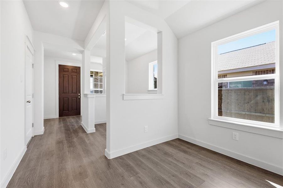 Foyer entrance with wood finished floors and recessed lighting