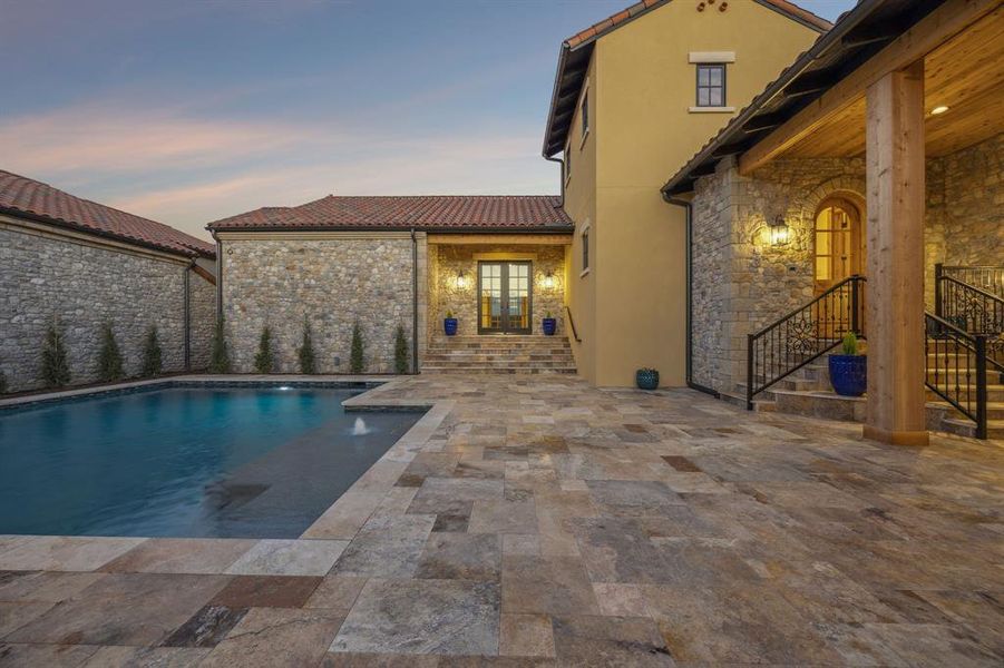 Swimming pool with a patio and french doors