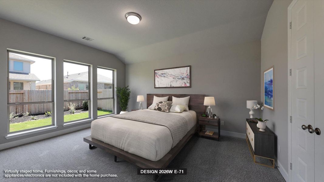 Carpeted bedroom featuring lofted ceiling and baseboards