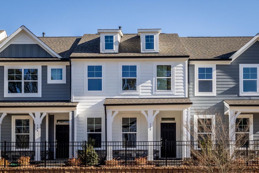 Front exterior of a new home in Enclave at Traditions Townhomes, Wake Forest, NC, highlighting curb appeal (Image 1). Front exterior of a new home in Enclave at Traditions Townhomes, Wake Forest, NC, highlighting curb appeal (Image 1).