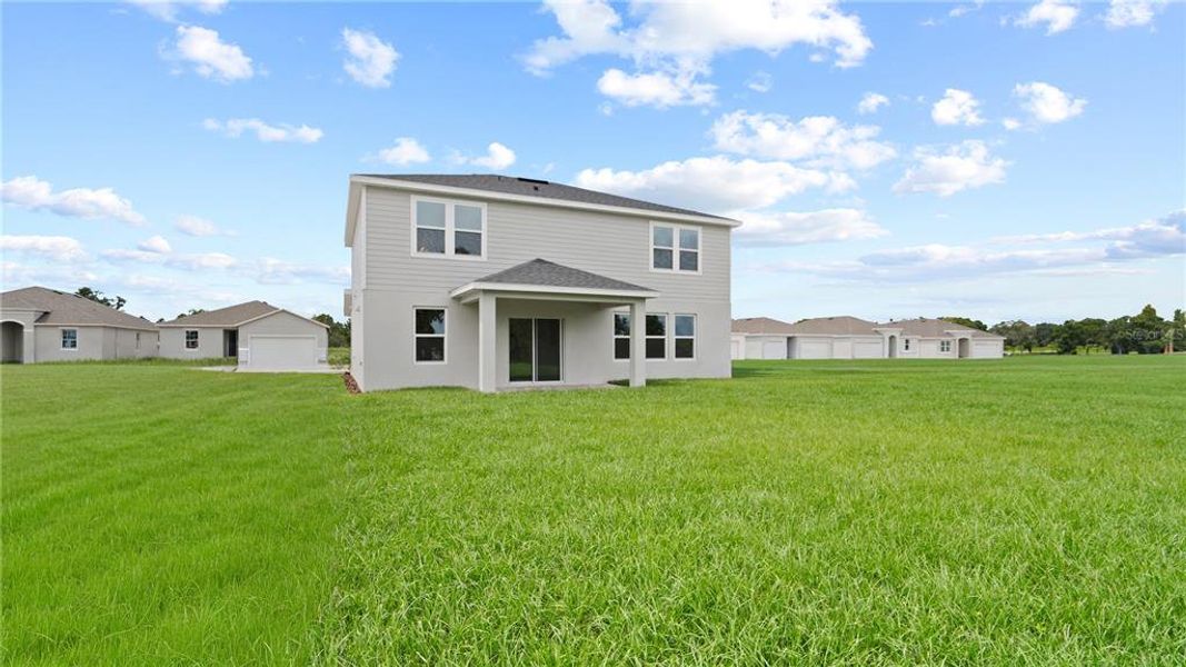 Front exterior of a new home in Willowbrook North, Winter Haven, FL, highlighting curb appeal (Image 1).