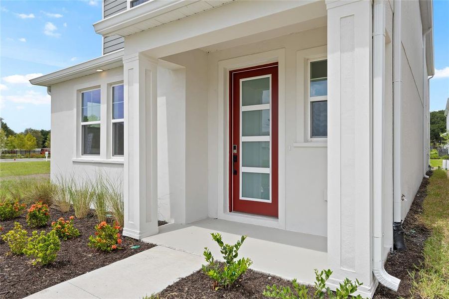 Front exterior of a new home in Vivir, Valrico, FL, highlighting curb appeal (Image 23).
