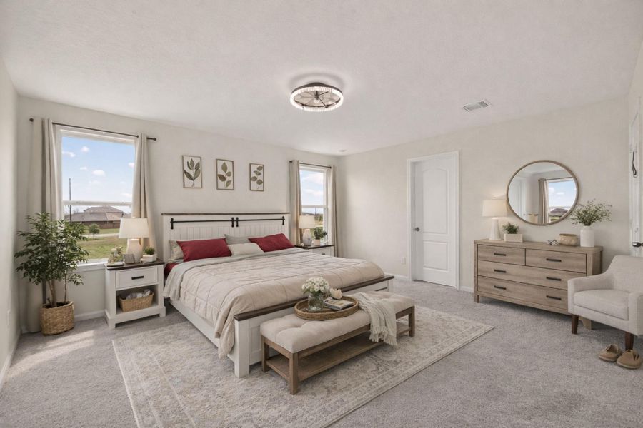 Light-filled primary bedroom with plush carpet, oversized windows, and a modern ceiling light fixture.