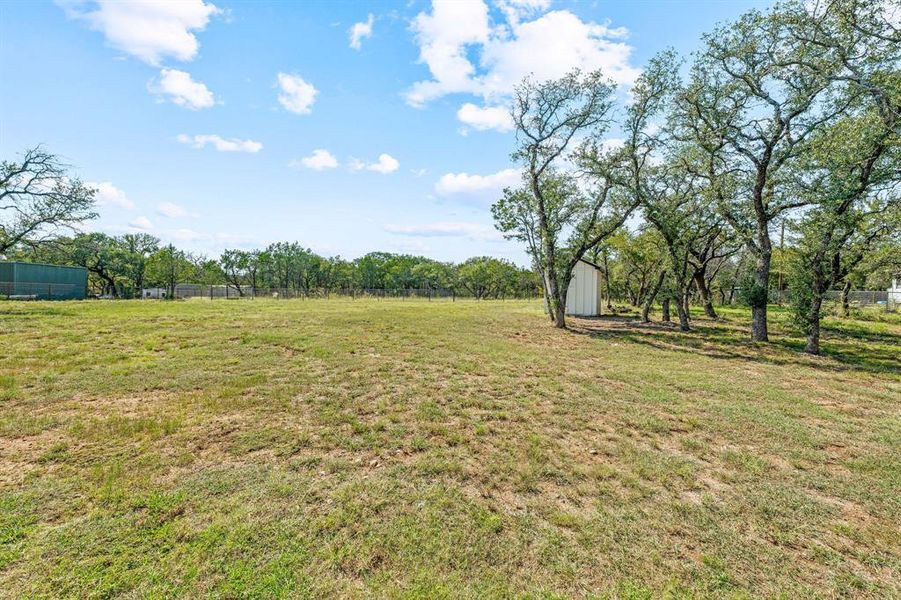 View of yard featuring a storage shed and a view of countryside View of yard featuring a storage shed and a view of countryside