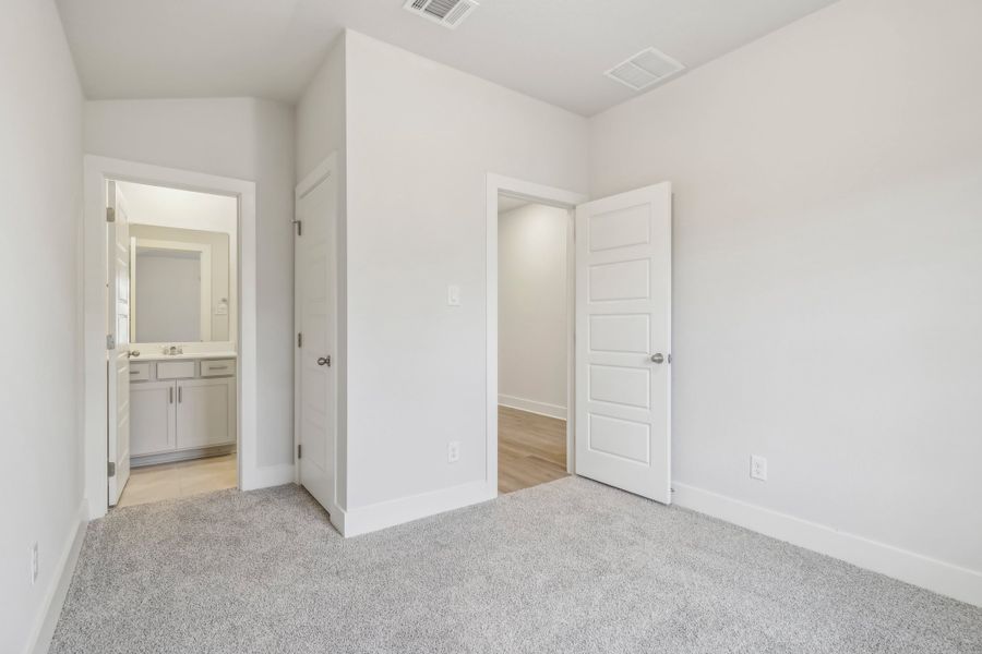 Guest bedroom in the Hughes floorplan at a Meritage Homes community.