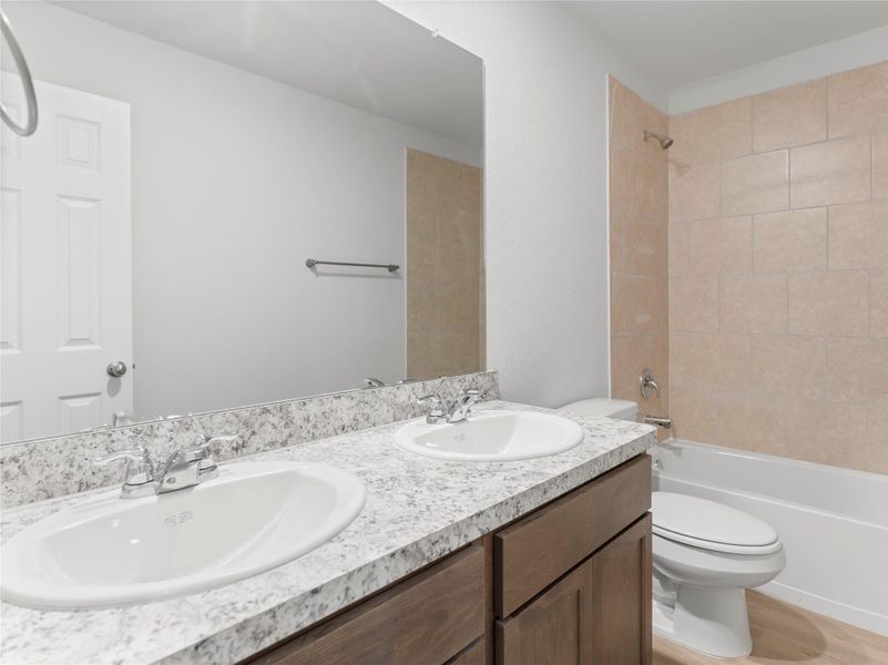 Elegant upstairs bathroom featuring a double-sink vanity. Elegant upstairs bathroom featuring a double-sink vanity.