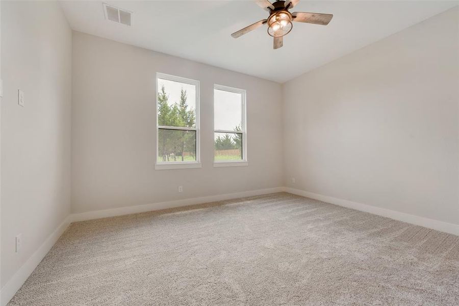 Unfurnished room with carpet and ceiling fan