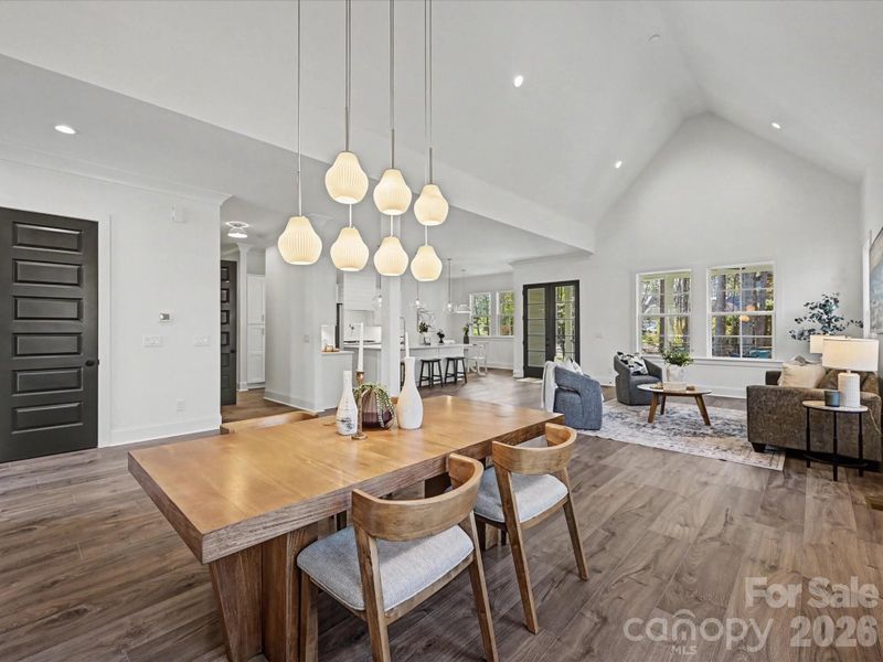 Elegant dining room with designer lighting, seamlessly flowing into the open-concept living space—perfect for entertaining and gatherings.