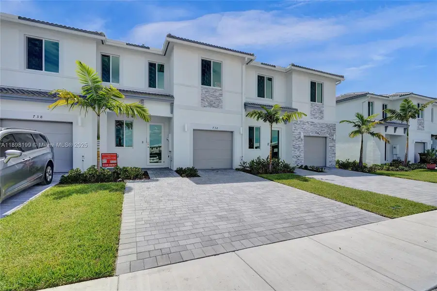 Front exterior of a new home in , Homestead, FL, highlighting curb appeal (Image 1). Front exterior of a new home in , Homestead, FL, highlighting curb appeal (Image 1).