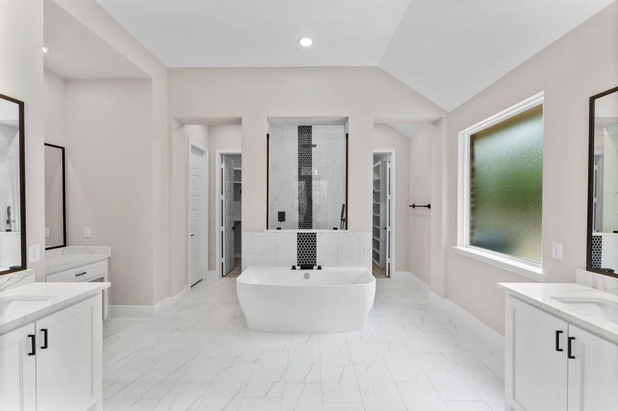 Luxurious primary bath with double closets